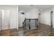 Hallway featuring wood floors and a dark wooden staircase with decorative railing at 11918 Winterset Cove Dr, Riverview, FL 33579