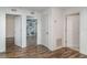 Hallway featuring wood floors and white doors leading to bedrooms and bathrooms at 11918 Winterset Cove Dr, Riverview, FL 33579