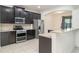 Modern kitchen features stainless steel appliances, granite countertops, and dark wood cabinetry at 11918 Winterset Cove Dr, Riverview, FL 33579