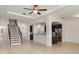 Open-concept living area with staircase, granite countertops, and stainless steel appliances at 11918 Winterset Cove Dr, Riverview, FL 33579