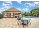 Resort-style pool area with lounge chairs, tables, covered seating, and a well-maintained deck at 11918 Winterset Cove Dr, Riverview, FL 33579