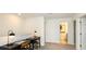 Upstairs hallway with desks, providing a dedicated workspace with natural light at 12474 Gust Ct, Hudson, FL 34669