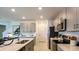 Well-lit kitchen with modern appliances, including stainless steel refrigerator and open island area at 12474 Gust Ct, Hudson, FL 34669