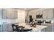 Modern kitchen with stainless steel appliances, ample cabinet space, and a center island with seating at 12474 Gust Ct, Hudson, FL 34669
