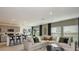 Open-concept living area featuring a modern kitchen, breakfast bar, and comfortable seating at 12474 Gust Ct, Hudson, FL 34669