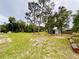 Expansive backyard featuring mature trees, a shed, and plenty of space for recreation and gardening at 13186 Thrush St, Spring Hill, FL 34609