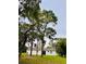 A distant view of the home behind an array of trees at 13186 Thrush St, Spring Hill, FL 34609