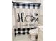 Cozy bathroom with a 'Home Sweet Home' shower curtain and white subway tile walls at 13186 Thrush St, Spring Hill, FL 34609