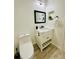 Modern bathroom features a toilet, white vanity with a sink, and contemporary fixtures at 13186 Thrush St, Spring Hill, FL 34609