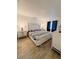 Spacious bedroom with a king bed, white furniture, and wood-look tile flooring at 13186 Thrush St, Spring Hill, FL 34609