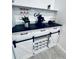 Chic coffee bar features white cabinetry, a black countertop, wine glass rack, and sliding barn doors at 13186 Thrush St, Spring Hill, FL 34609