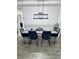 Bright dining room featuring a table for six, modern light fixture, and stylish decor at 13186 Thrush St, Spring Hill, FL 34609