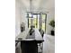 Cozy dining area with table for six overlooking a lush backyard through a sliding glass door at 13186 Thrush St, Spring Hill, FL 34609