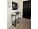 Welcoming entryway features a console table, decor, and a stylish black front door at 13186 Thrush St, Spring Hill, FL 34609