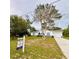 Charming single-story home with a well-maintained lawn and a 'For Sale' sign on the property at 13186 Thrush St, Spring Hill, FL 34609