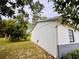 Exterior side view showing clean white walls and well-maintained yard at 13186 Thrush St, Spring Hill, FL 34609