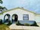 Inviting home exterior with gray brick accents, manicured greenery, and a cozy front porch at 13186 Thrush St, Spring Hill, FL 34609