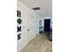 Bright hallway featuring wood-look tile flooring and a decorative HOME sign, creating a warm and welcoming entrance at 13186 Thrush St, Spring Hill, FL 34609