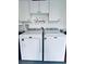 Laundry room equipped with Maytag washer and dryer and storage cabinets at 13186 Thrush St, Spring Hill, FL 34609