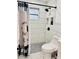 Bright bathroom with a shower featuring modern black fixtures and white subway tiles at 13186 Thrush St, Spring Hill, FL 34609