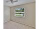 Bedroom with neutral carpet and a window view of lush greenery outside at 1331 Coolmont Dr, Brandon, FL 33511