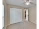 Cozy bedroom with ceiling fan, closet, carpeted flooring, and an open door at 1331 Coolmont Dr, Brandon, FL 33511