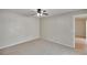 Spacious bedroom featuring neutral carpet, a ceiling fan, and natural light at 1331 Coolmont Dr, Brandon, FL 33511