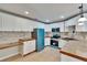 Bright kitchen with white cabinets, unique backsplash, and retro blue appliances at 1331 Coolmont Dr, Brandon, FL 33511