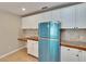 Updated kitchen featuring white cabinets and new retro blue refrigerator at 1331 Coolmont Dr, Brandon, FL 33511
