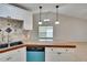 Stylish kitchen with white cabinetry, modern appliances, and a bar counter at 1331 Coolmont Dr, Brandon, FL 33511