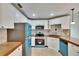 Bright kitchen with white cabinetry, wood counters, and blue appliances at 1331 Coolmont Dr, Brandon, FL 33511