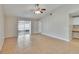 Bright living room with tiled flooring, ceiling fan, and sliding door access to the outdoors at 1331 Coolmont Dr, Brandon, FL 33511