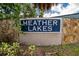 Heather Lakes community sign amidst lush greenery and stone, conveying a welcoming neighborhood at 1331 Coolmont Dr, Brandon, FL 33511