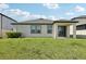 Exterior view of a home with a covered patio and lush green lawn at 13515 Palmera Vista Dr, Riverview, FL 33579
