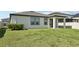Well maintained backyard with green lawn, mature shrubs, and a covered lanai at 13515 Palmera Vista Dr, Riverview, FL 33579