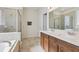 Elegant bathroom featuring double sinks, granite countertops, and a glass-enclosed shower for modern luxury at 13515 Palmera Vista Dr, Riverview, FL 33579
