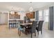 Open-concept dining area with stylish chandelier and seamless flow to the kitchen at 13515 Palmera Vista Dr, Riverview, FL 33579