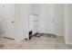 Clean entryway with tile flooring, white storage cabinet and adjacent closet at 13515 Palmera Vista Dr, Riverview, FL 33579
