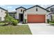 Charming single-story home featuring a two-car garage, a well-manicured lawn, and lovely curb appeal at 13515 Palmera Vista Dr, Riverview, FL 33579