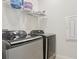 Modern laundry room with sleek, gray Samsung washer and dryer units at 13515 Palmera Vista Dr, Riverview, FL 33579
