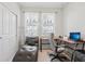 Bright office space features a large desk, comfortable seating, and ample natural light at 13515 Palmera Vista Dr, Riverview, FL 33579