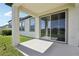 Covered patio overlooking a well-manicured backyard with sliding glass doors at 13515 Palmera Vista Dr, Riverview, FL 33579