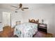 Well-lit bedroom with ceiling fan, wood floors, and a comfortable bed at 13710 Mission Oaks Blvd # 2A, Seminole, FL 33776
