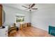Bedroom with ceiling fan, wood flooring, and view to the outside at 13710 Mission Oaks Blvd # 2A, Seminole, FL 33776