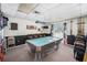 Inside the recreational room there is a large billiards table, several chairs, and bar decor at 13710 Mission Oaks Blvd # 2A, Seminole, FL 33776