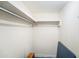 Walk-in closet with shelving and hanging rod; closet is empty except for small table at 13710 Mission Oaks Blvd # 2A, Seminole, FL 33776