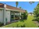 Exterior view of condo building with well maintained landscaping, glass windows and doors at 13710 Mission Oaks Blvd # 2A, Seminole, FL 33776