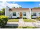Charming single-story home featuring a well-maintained lawn, neutral color palette, and inviting entrance at 13710 Mission Oaks Blvd # 2A, Seminole, FL 33776