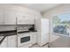 Efficient kitchen featuring all-white appliances and lots of countertop space at 13710 Mission Oaks Blvd # 2A, Seminole, FL 33776