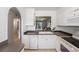 View from kitchen over-looking sink, countertops, dishwasher, and stove area at 13710 Mission Oaks Blvd # 2A, Seminole, FL 33776